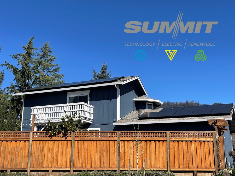 Beautiful home with solar panels on the roof and a bright blue sky beyond. 