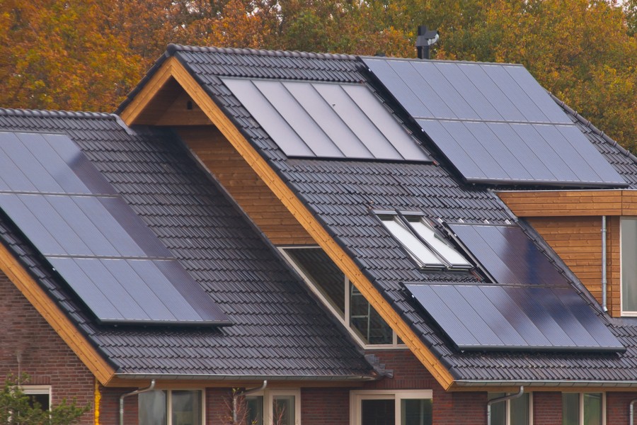 Photo of a beautiful home with solar panels on the roof. 