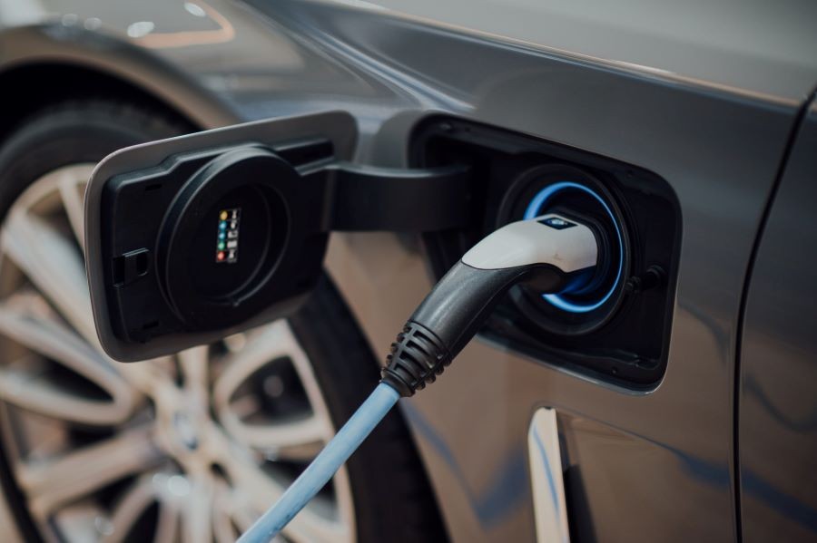 An electrical vehicle plugged into an EV charger.