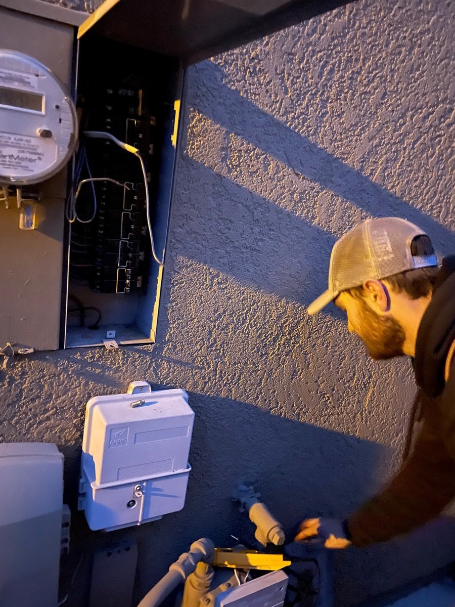 An electrician working on home electrical panels.