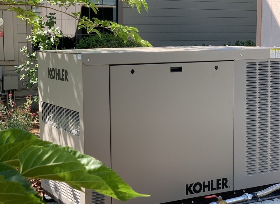 A Kohler home generator installed outside a home.