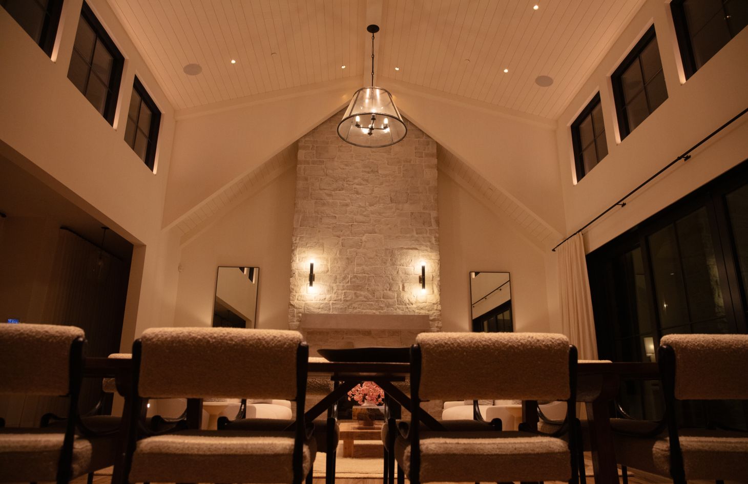 A stylish home office with a minimalist desk setup, ergonomic seating, and contemporary decor elements, all bathed in natural light from large windows.