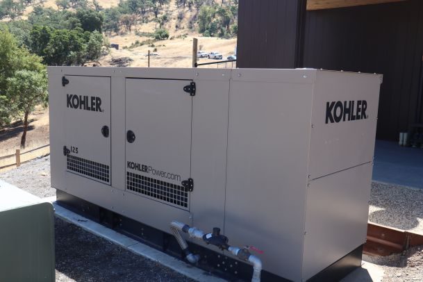 A Kohler standby generator installed outside a home, designed to provide backup power during outages.
