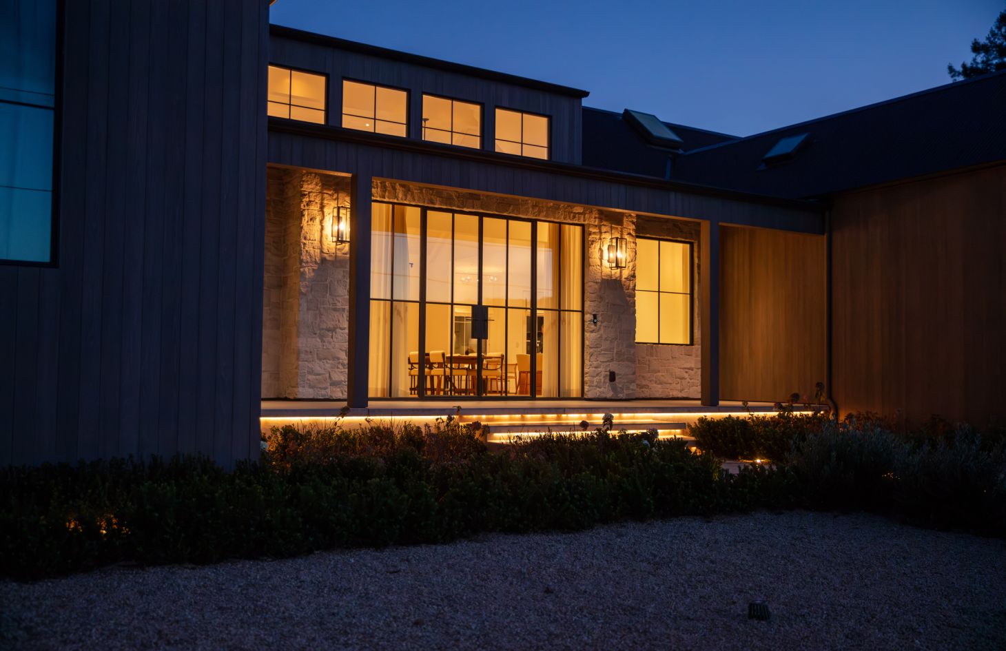 A bright, airy dining area with a minimalist table set, stylish chairs, and large windows offering scenic views, evoking a sense of modern elegance.