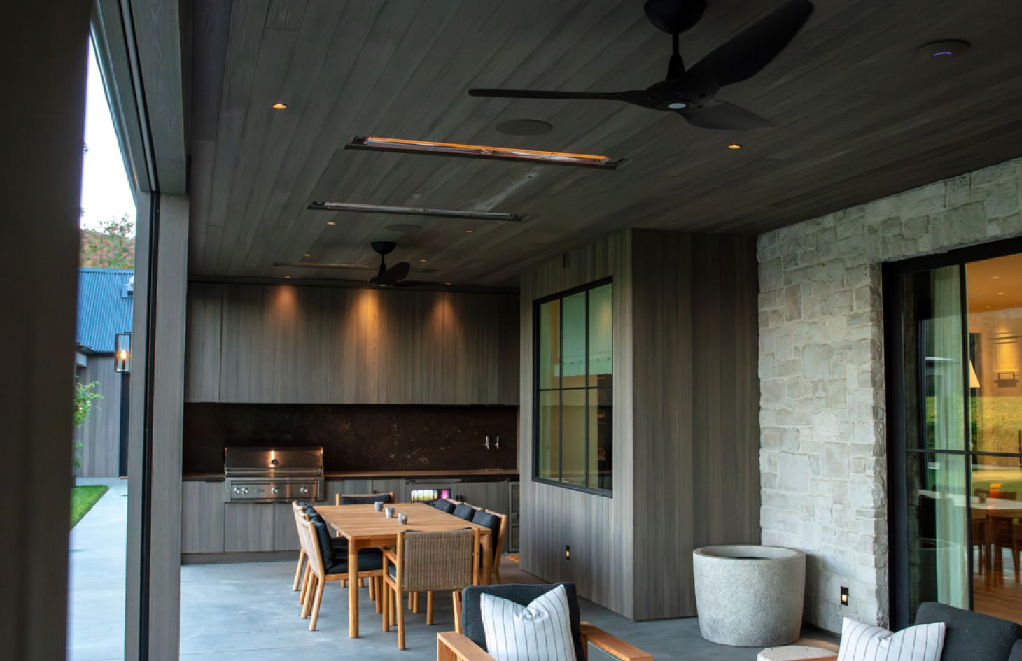 A panoramic view of a modern living space featuring an open-plan layout, sleek contemporary furniture, and large windows that flood the room with daylight.