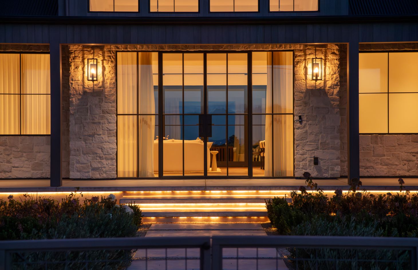 A spacious open-plan interior featuring clean lines, floor-to-ceiling windows, and modern furniture that emphasizes simplicity and sophistication.